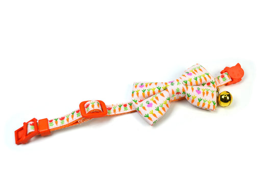 a bow tie with a bell on a white background