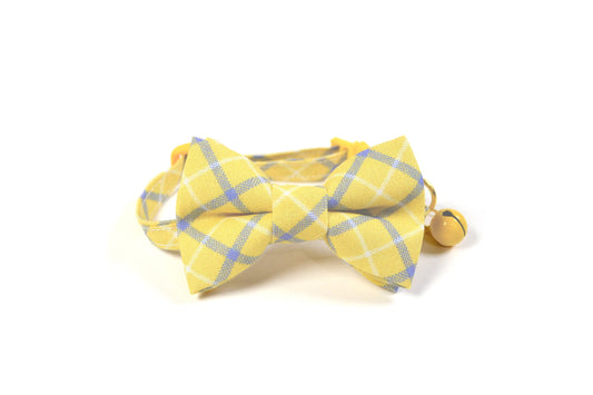 a yellow bow tie on a white background