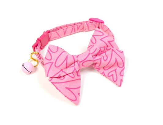 a pink bow tie with a pink heart on it